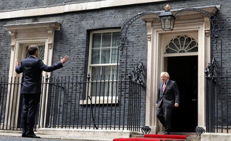 French President Emmanuel Macron gestures as he meets Britain's Prime Minister Boris Johnson at Downing Street in London, Britain. REUTERS/Hannah McKay/Pool  